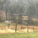 Rustic arbor seen through rain-streaked window